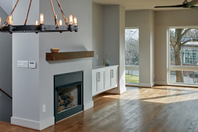 Photo of an expansive urban open plan games room in Atlanta with grey walls, medium hardwood flooring, a standard fireplace, a metal fireplace surround and a wall mounted tv.