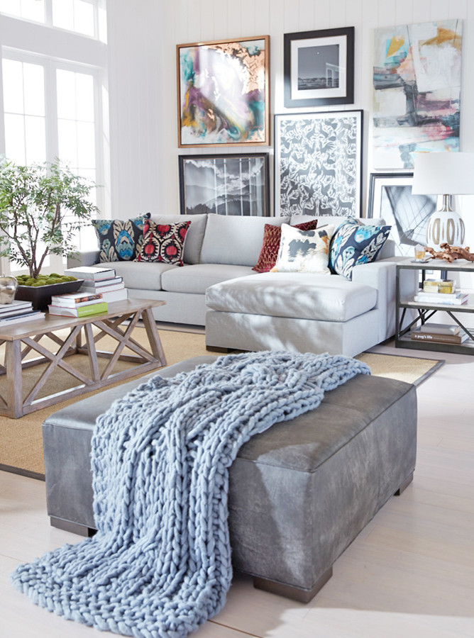 This is an example of a large eclectic open plan games room with white walls, light hardwood flooring, no fireplace, no tv and beige floors.