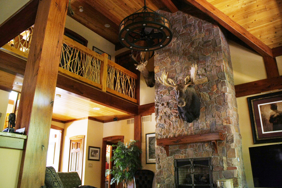 Rustic mezzanine games room in Detroit with a standard fireplace and a stone fireplace surround.