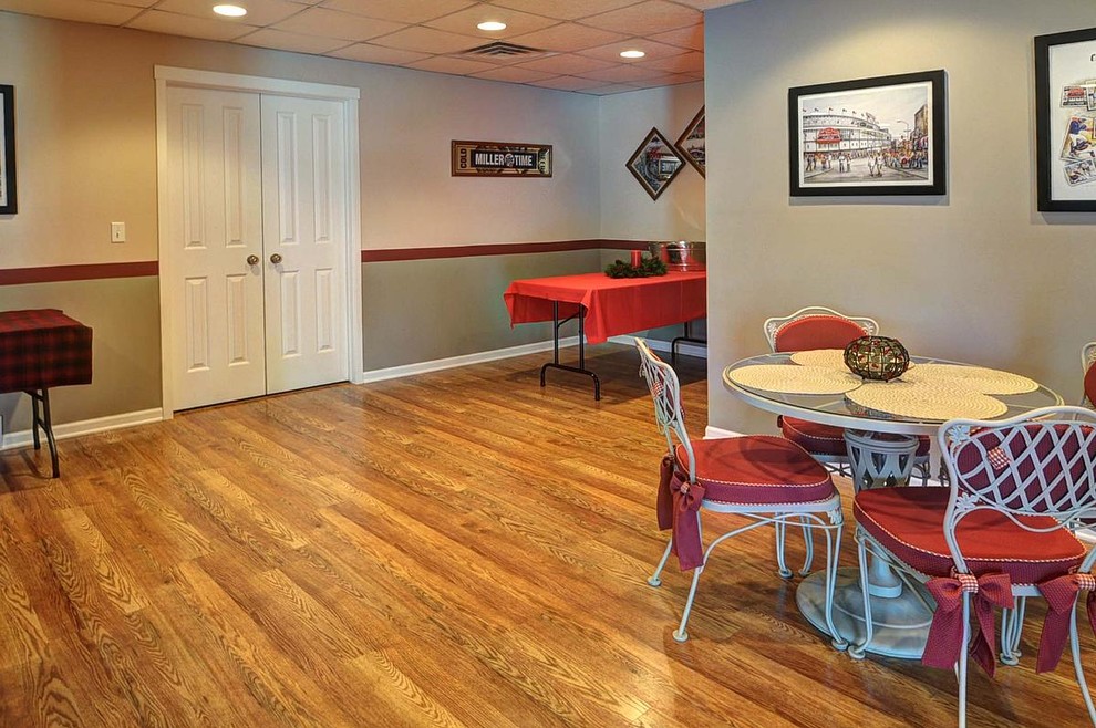 Inspiration for a large rustic open plan games room in Milwaukee with a game room, multi-coloured walls and medium hardwood flooring.