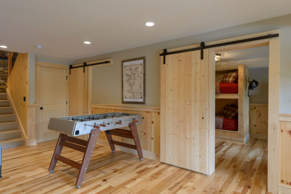 Example of a mid-sized mountain style enclosed light wood floor and beige floor game room design in Boston with gray walls, no fireplace and no tv