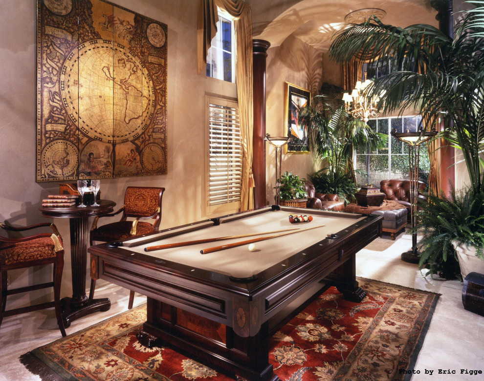 This is an example of a large classic enclosed games room in Orange County with beige walls, no fireplace, beige floors and limestone flooring.