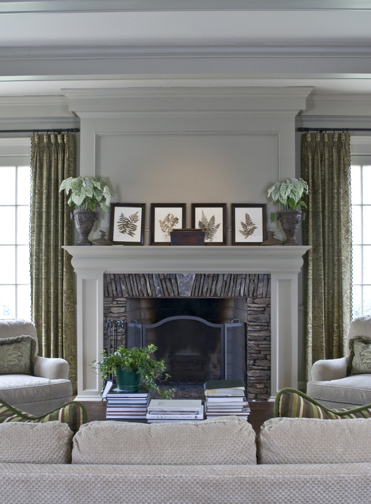 Family room - traditional family room idea in Atlanta with beige walls, a standard fireplace, a stone fireplace and no tv