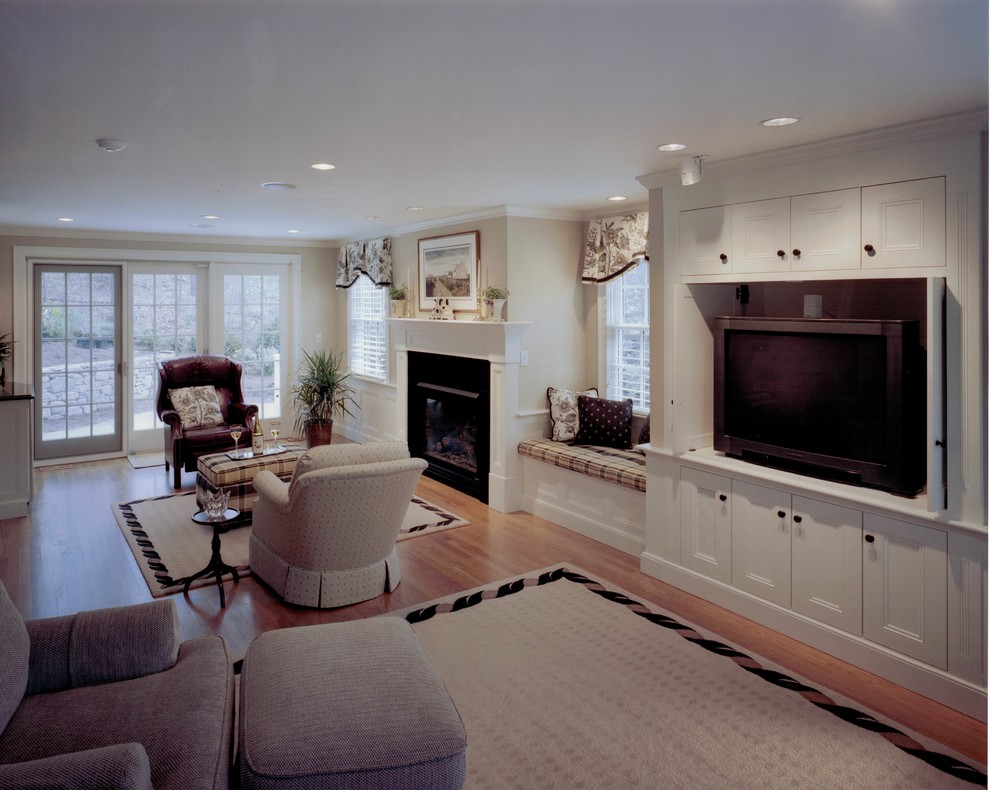 Large elegant open concept medium tone wood floor and brown floor family room photo in Boston with beige walls, a standard fireplace, a metal fireplace and a tv stand
