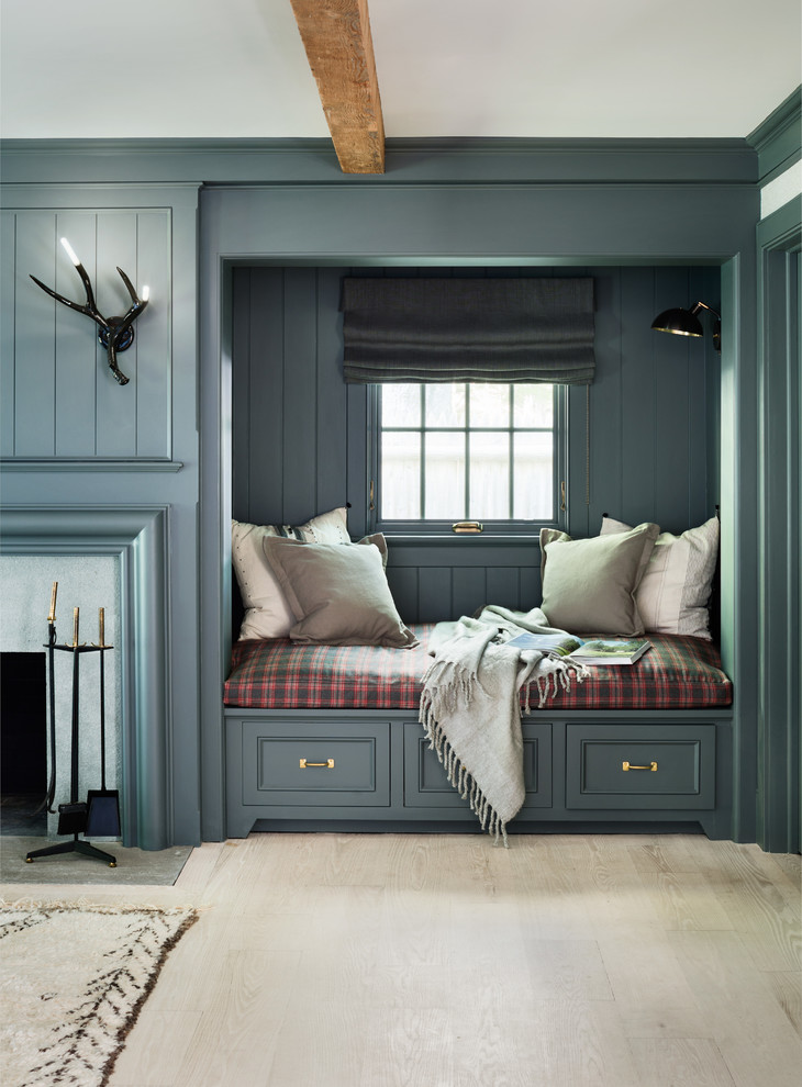 Immagine di un soggiorno classico con parquet chiaro, camino classico e pareti grigie