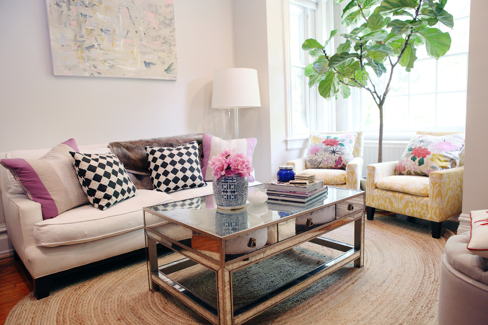 Example of a classic medium tone wood floor family room design in DC Metro with white walls