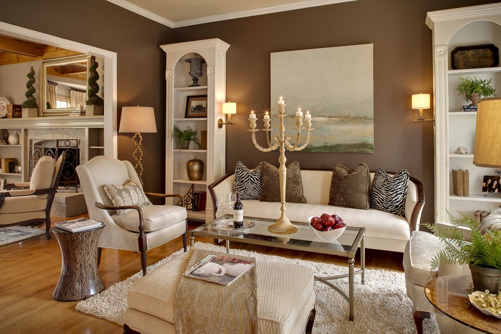 Inspiration for a timeless medium tone wood floor family room remodel in Kansas City with brown walls