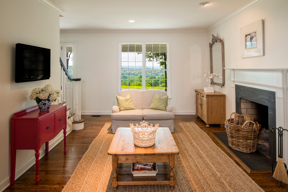 Example of a classic medium tone wood floor family room design in Baltimore with beige walls, a standard fireplace, a stone fireplace and a wall-mounted tv