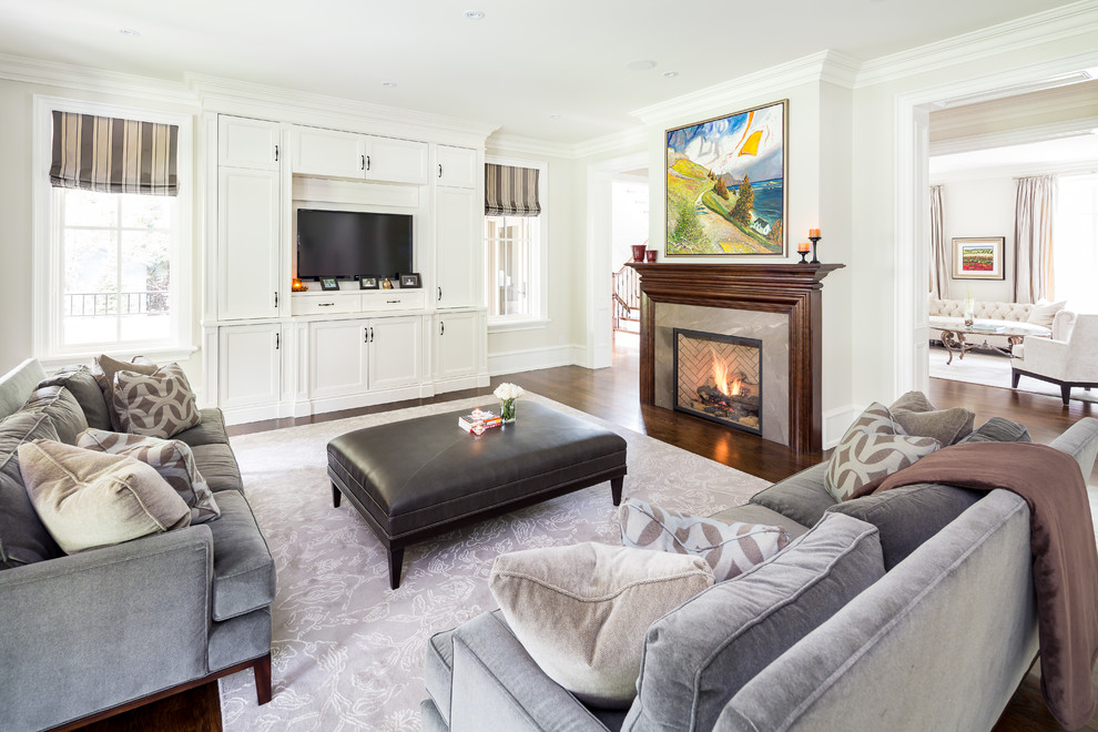 This is an example of a classic games room in Toronto with white walls, a standard fireplace and a built-in media unit.