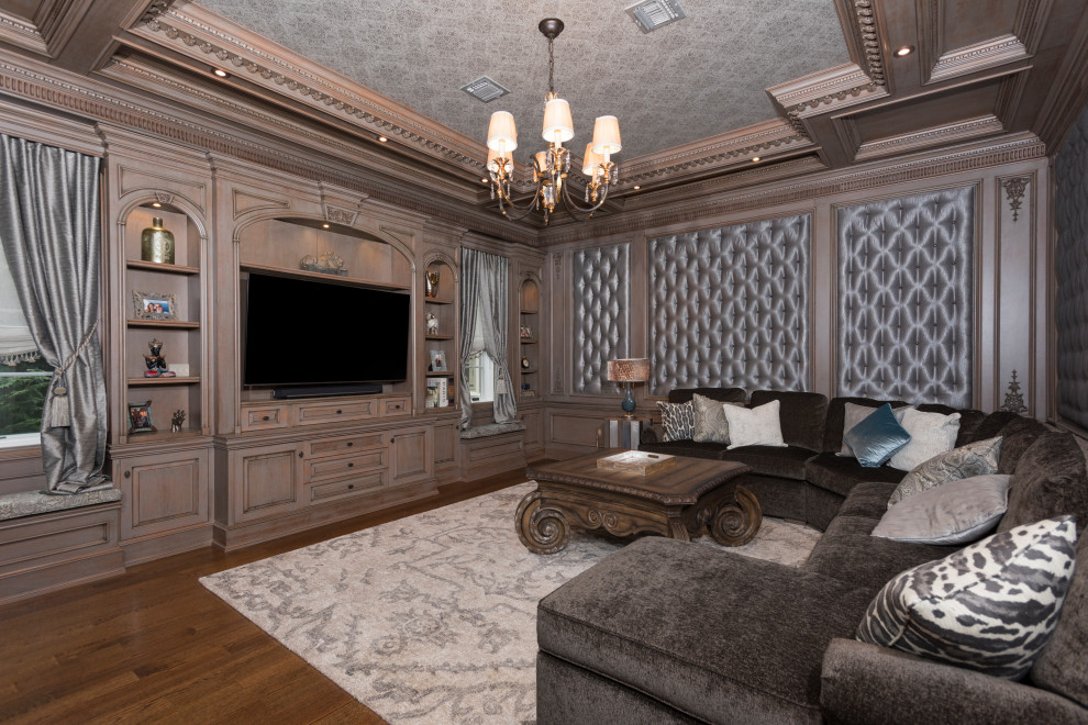 Esempio di un grande soggiorno chic con pavimento in legno massello medio, parete attrezzata, pareti marroni e pavimento marrone