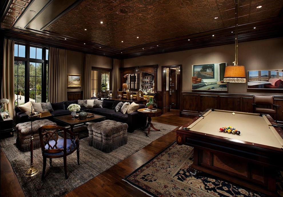 Photo of a large classic enclosed games room in Phoenix with a game room, brown walls, dark hardwood flooring and no tv.
