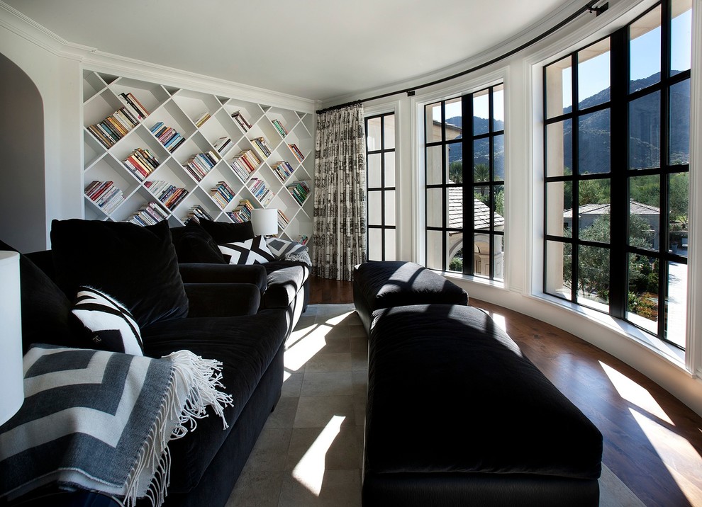 Example of a classic dark wood floor family room design in Phoenix with white walls