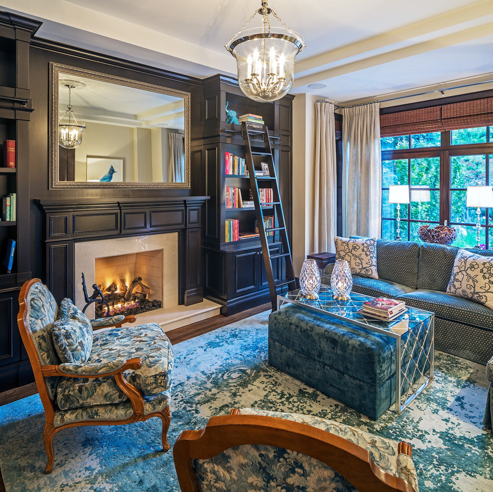 Inspiration for a medium sized classic enclosed games room in Toronto with a reading nook, a standard fireplace, a stone fireplace surround, a concealed tv, brown floors, black walls and medium hardwood flooring.