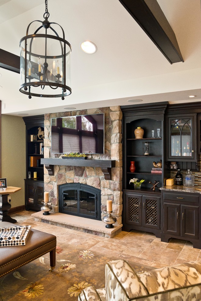 Medium sized classic open plan games room in New York with beige walls, a standard fireplace, a stone fireplace surround, a wall mounted tv, beige floors and porcelain flooring.