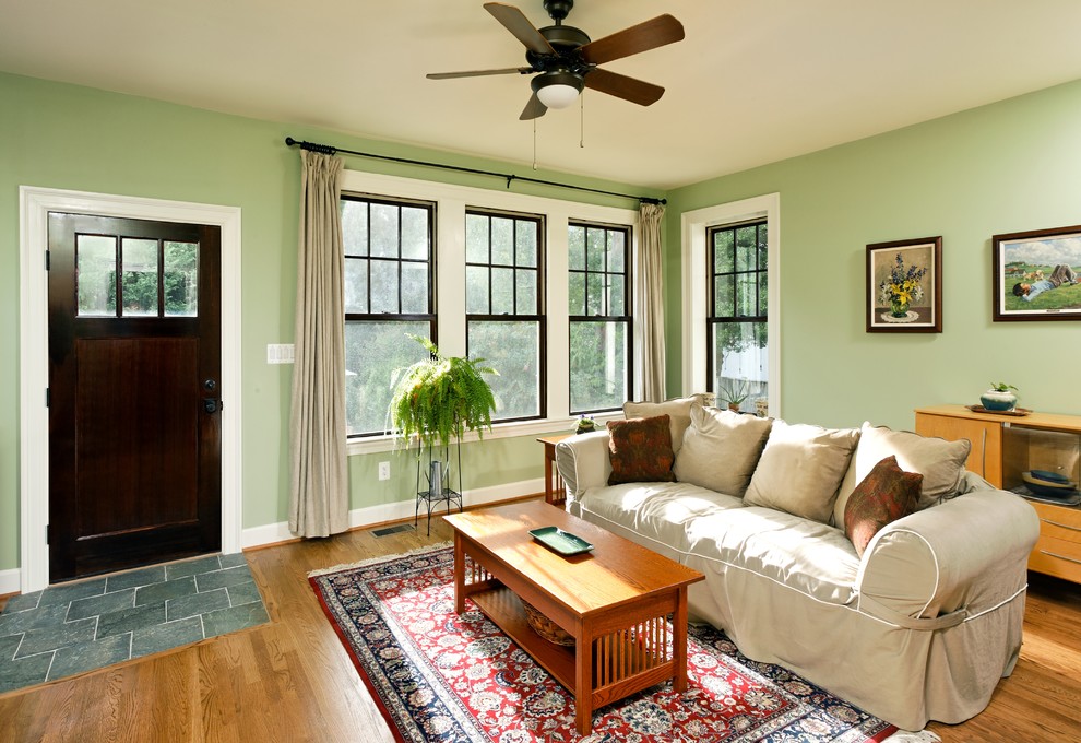 Family room - mid-sized mediterranean open concept medium tone wood floor family room idea in DC Metro with green walls