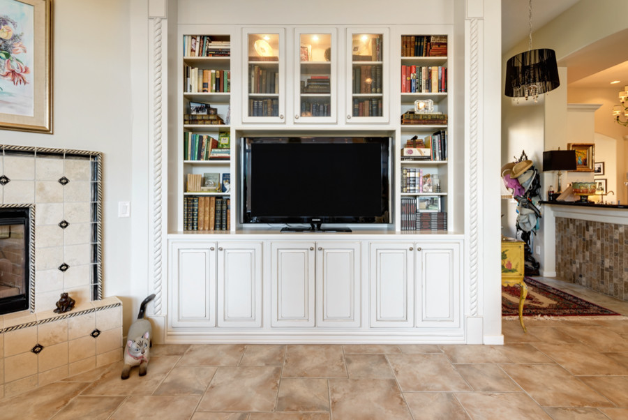 Family room - mid-sized traditional open concept porcelain tile family room idea in Phoenix with beige walls, a corner fireplace, a tile fireplace and a tv stand