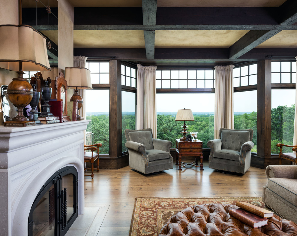 Classic open plan games room in Minneapolis with beige walls, dark hardwood flooring, a standard fireplace, a stone fireplace surround and a concealed tv.