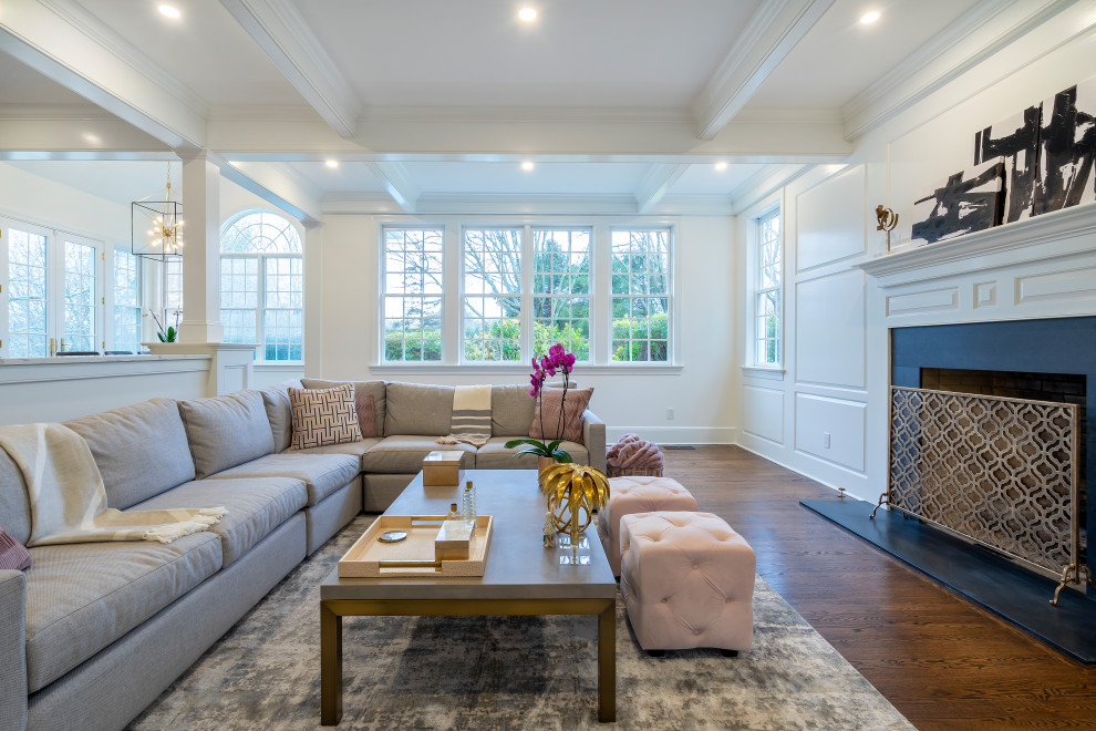 Inspiration for a large transitional open concept dark wood floor, brown floor, coffered ceiling and wall paneling family room remodel in Philadelphia with white walls, a standard fireplace, a wall-mounted tv and a wood fireplace surround
