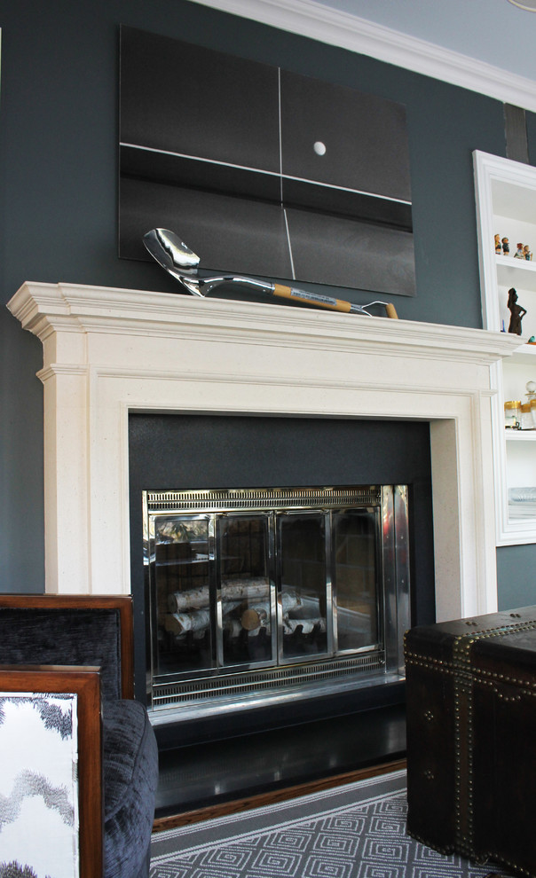 Example of a mid-sized transitional enclosed medium tone wood floor family room library design in New York with green walls, a ribbon fireplace and a plaster fireplace