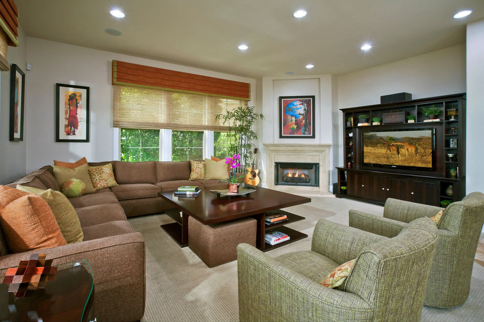 Design ideas for a large traditional open plan games room in Orange County with white walls, carpet, a standard fireplace, a concrete fireplace surround, a built-in media unit and grey floors.