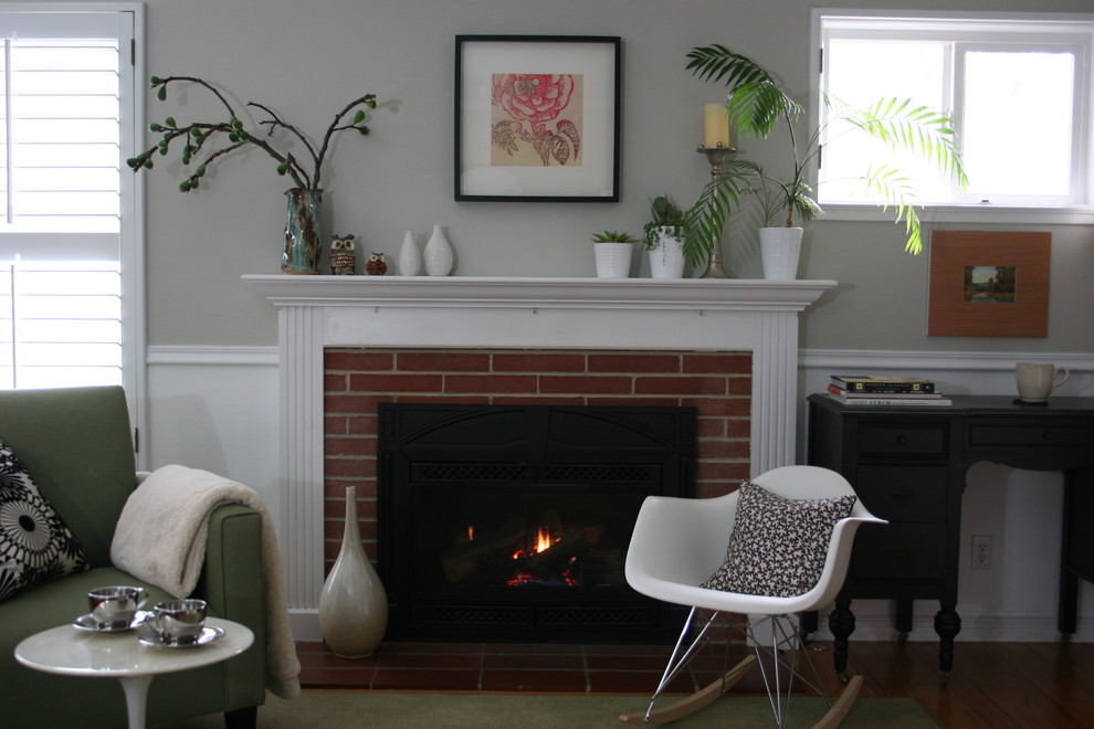 Example of a transitional family room design in San Francisco with a brick fireplace