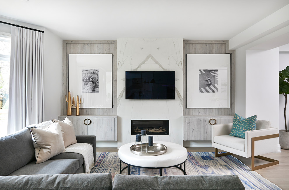 Transitional light wood floor and beige floor family room photo in Toronto with white walls, a ribbon fireplace and a wall-mounted tv