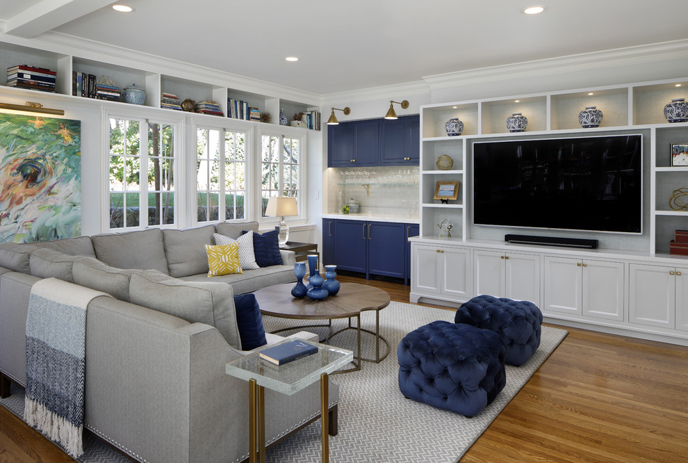 Immagine di un soggiorno tradizionale con pareti bianche, pavimento in legno massello medio, TV a parete e pavimento marrone