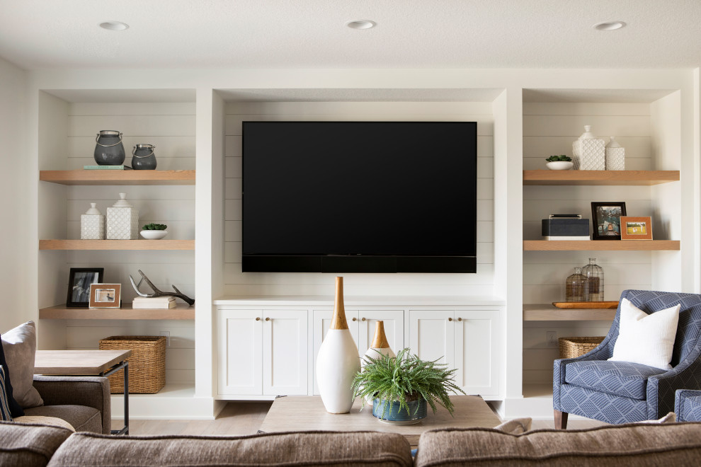 Inspiration for an expansive rural open plan games room in Minneapolis with white walls, light hardwood flooring, a built-in media unit, beige floors and tongue and groove walls.
