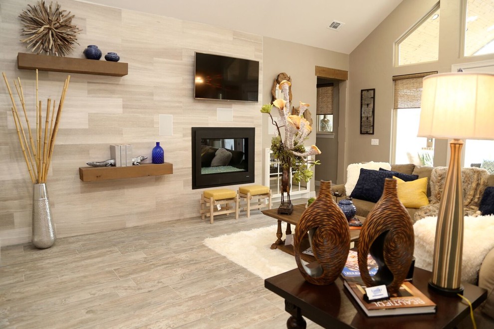 Photo of a medium sized traditional open plan games room with beige walls, dark hardwood flooring, a standard fireplace, a metal fireplace surround and a wall mounted tv.