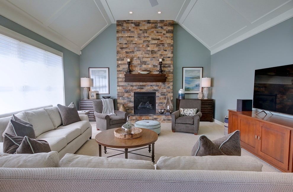Inspiration for a medium sized traditional enclosed games room in Cleveland with grey walls, medium hardwood flooring, a standard fireplace, a stone fireplace surround, a freestanding tv and brown floors.