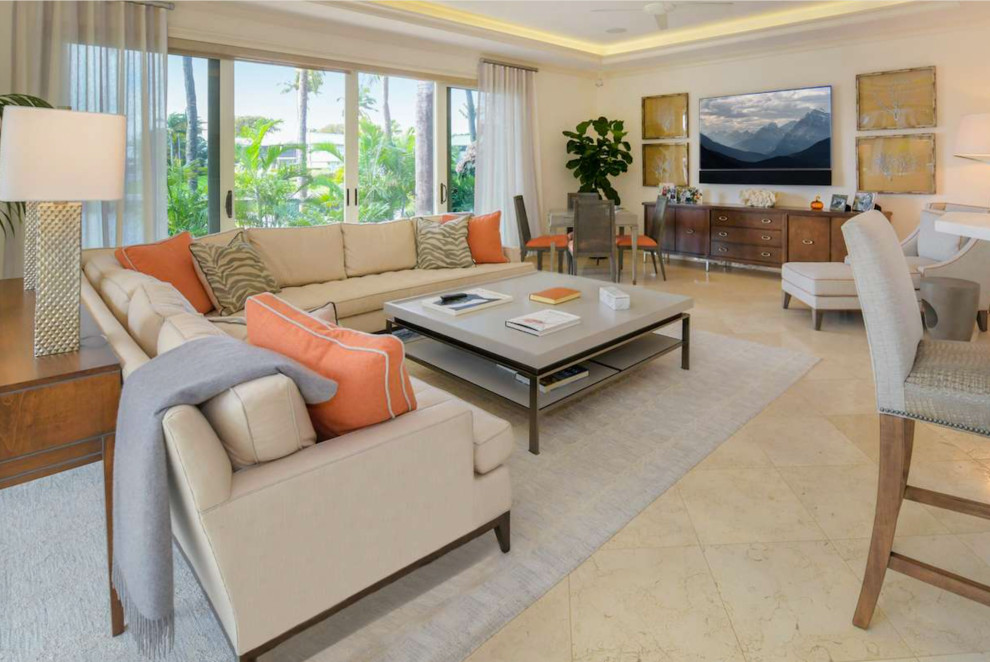 Example of a large transitional open concept travertine floor and beige floor game room design with beige walls and a wall-mounted tv