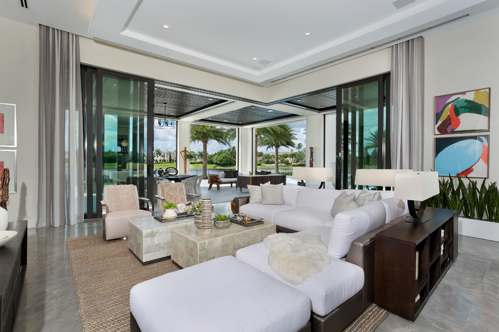 Photo of an expansive contemporary enclosed games room in Miami with porcelain flooring, beige walls and grey floors.