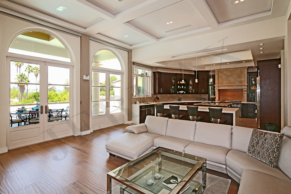 Photo of a large traditional open plan games room in Los Angeles with beige walls, medium hardwood flooring, no fireplace and brown floors.