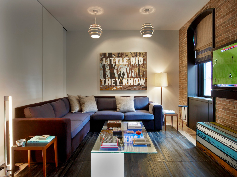 Family room - contemporary family room idea in New York with beige walls and a wall-mounted tv