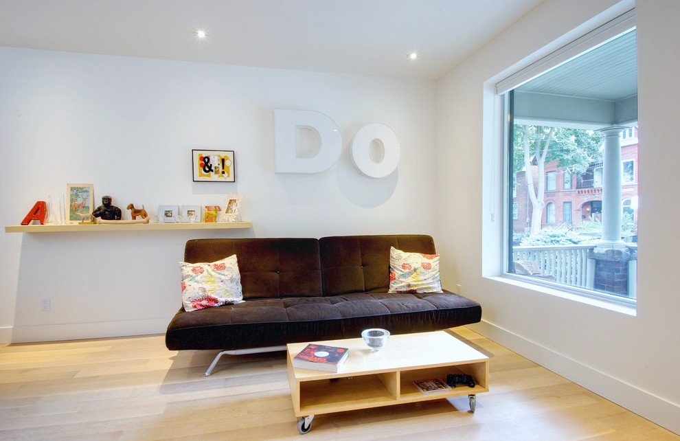 Inspiration for a modern light wood floor family room remodel in Toronto with white walls