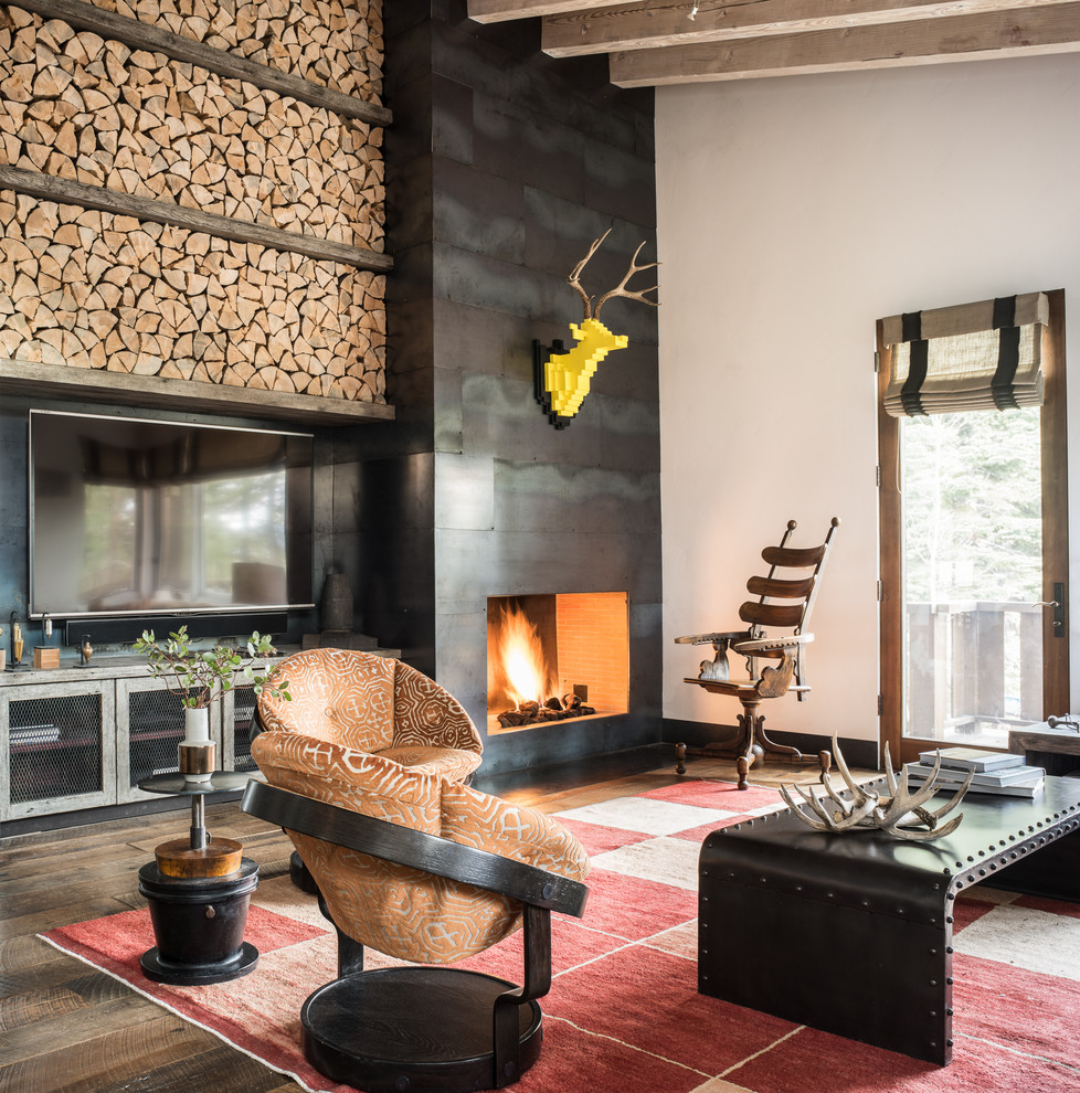 Design ideas for a rustic games room in San Francisco with a standard fireplace, a metal fireplace surround and a wall mounted tv.
