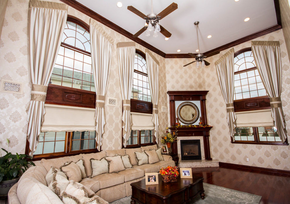 Mittelgroßes, Fernseherloses, Offenes Klassisches Wohnzimmer mit beiger Wandfarbe, dunklem Holzboden, Eckkamin, Kaminumrandung aus Holz und braunem Boden in New York