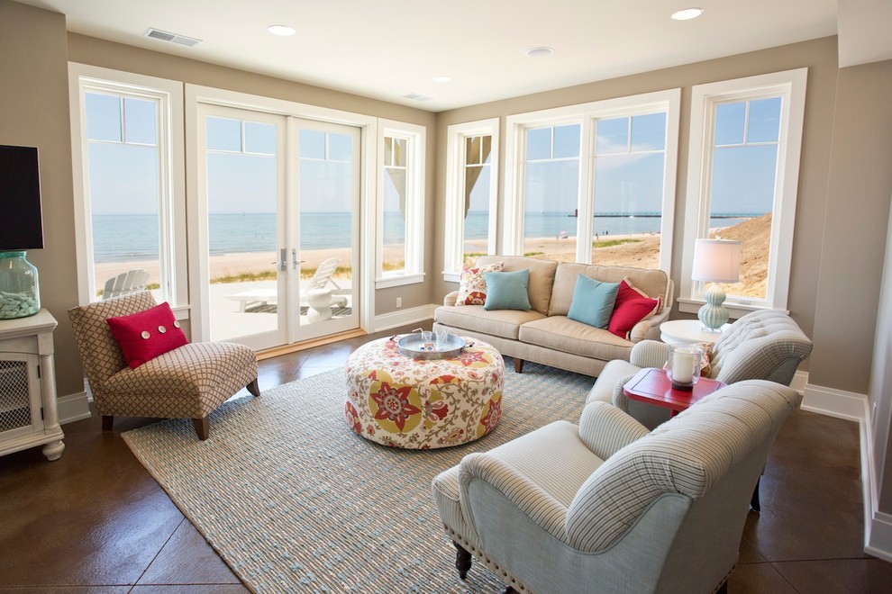Example of a large beach style open concept porcelain tile family room design in Grand Rapids with beige walls