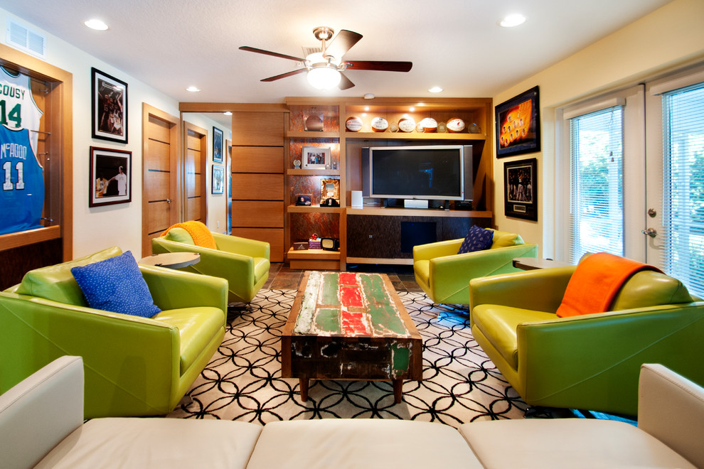 This is an example of an eclectic enclosed games room in Orlando with beige walls, dark hardwood flooring and a freestanding tv.
