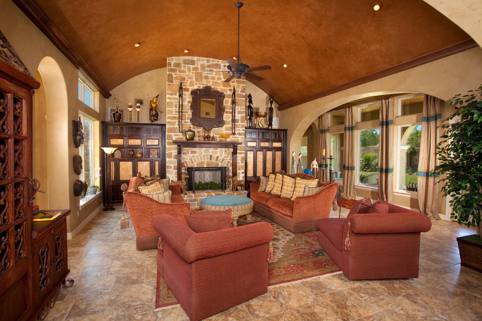 Mediterranean open plan games room in Austin with beige walls, a standard fireplace and a stone fireplace surround.