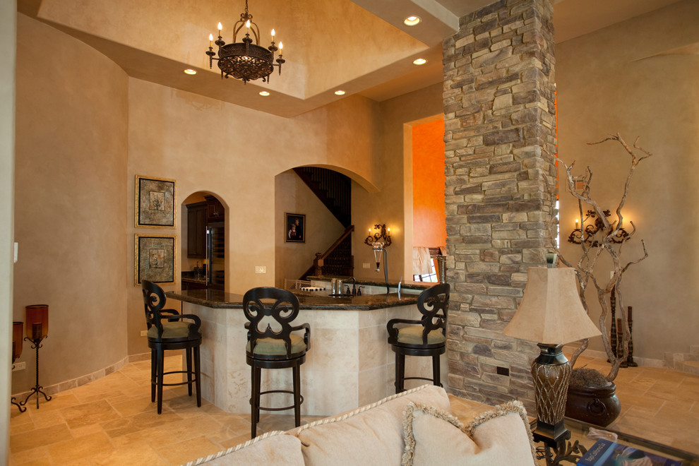 Inspiration for a large mediterranean open concept limestone floor family room remodel in Chicago with beige walls, a standard fireplace, a stone fireplace and no tv