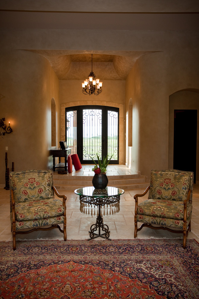 Example of a large tuscan open concept limestone floor family room design in Chicago with beige walls, a standard fireplace, a stone fireplace and no tv