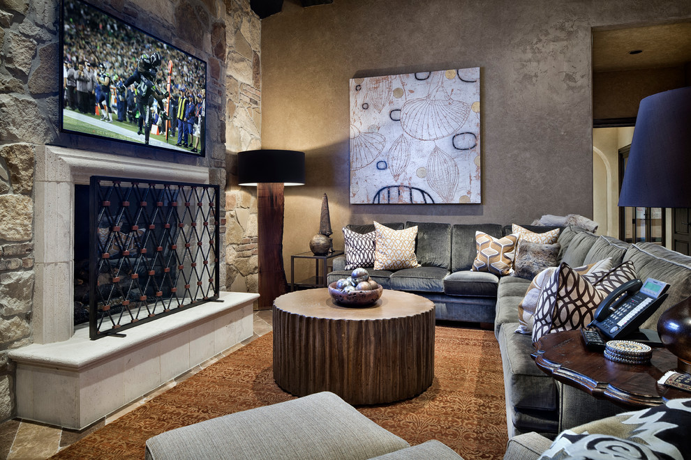 Example of a huge tuscan open concept family room design in Houston with a standard fireplace and a wall-mounted tv