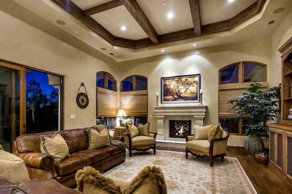 Mediterranean games room in San Francisco with beige walls, dark hardwood flooring, a standard fireplace and a stone fireplace surround.