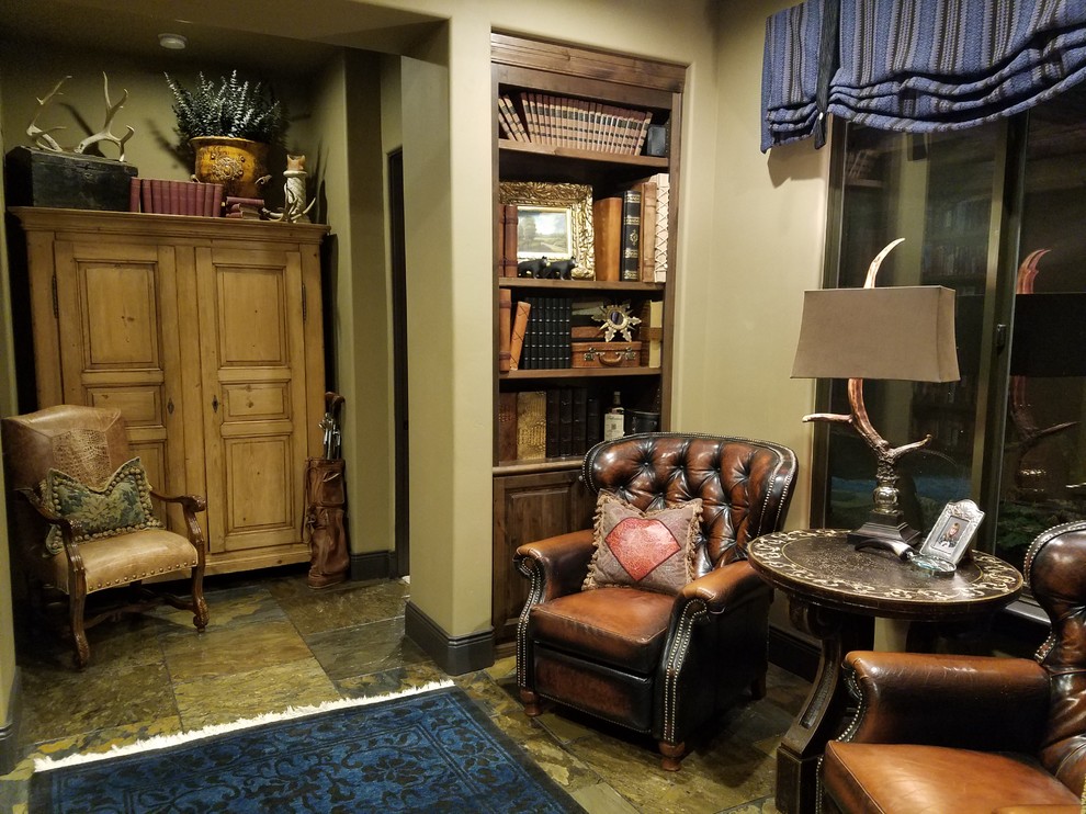 Tuscan slate floor family room library photo in Sacramento with beige walls and a media wall