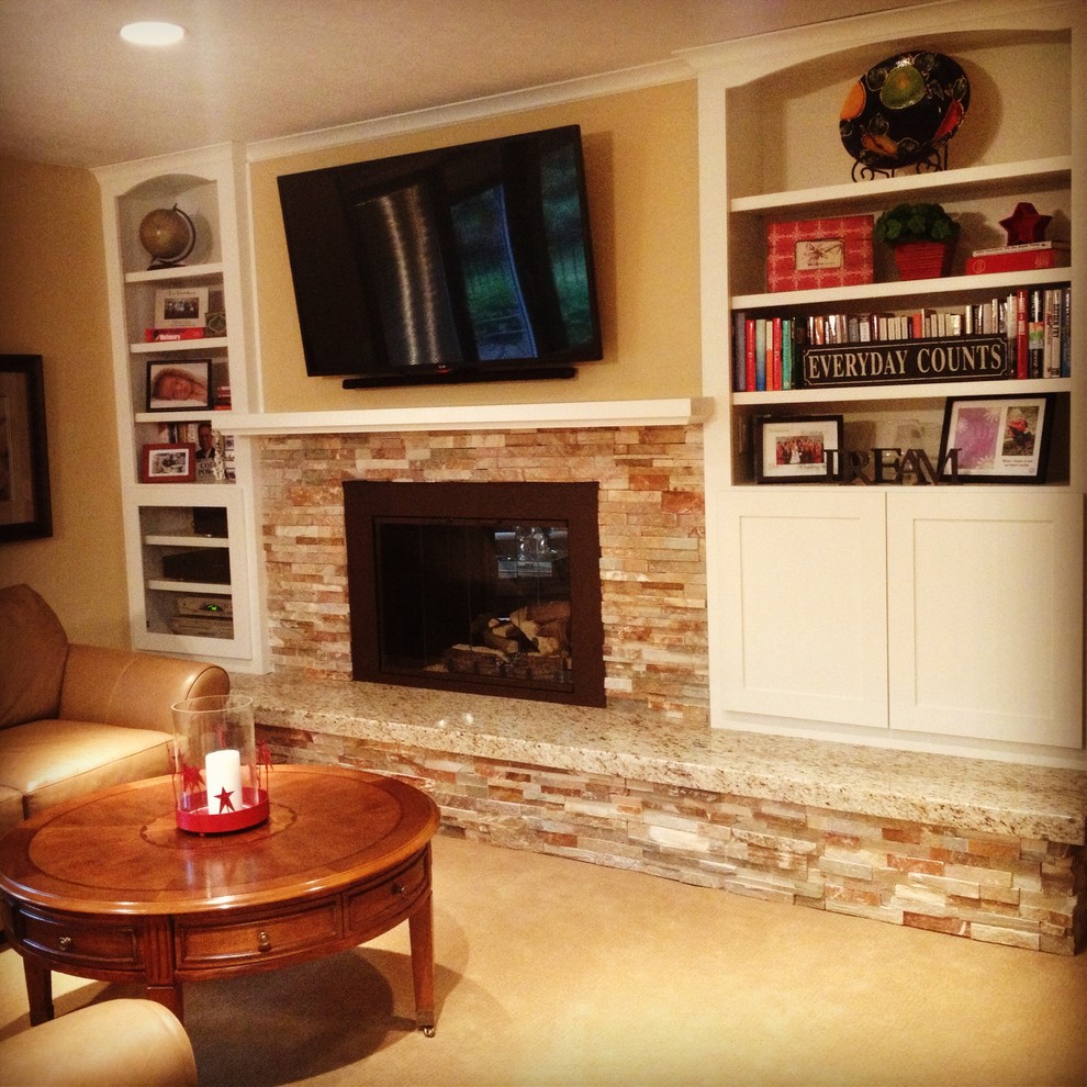 This is an example of a medium sized traditional open plan games room in Minneapolis with beige walls, carpet, a two-sided fireplace, a stone fireplace surround and a wall mounted tv.
