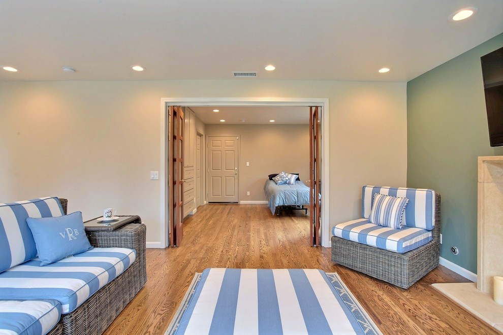 Large contemporary open plan games room in San Francisco with a game room, green walls, bamboo flooring, a standard fireplace, a tiled fireplace surround and a wall mounted tv.