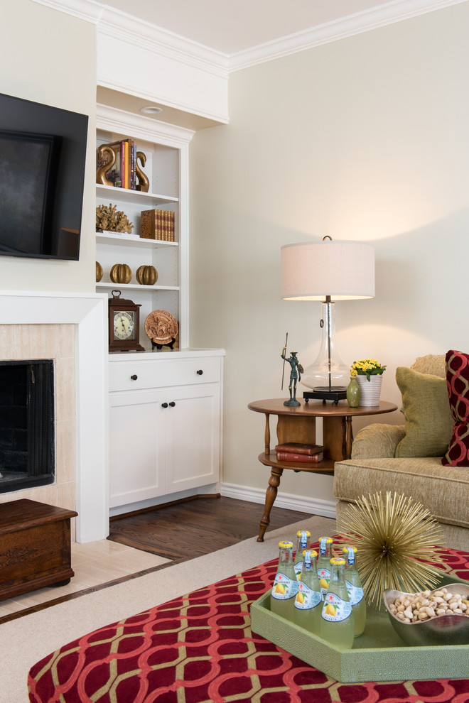 Mid-sized elegant open concept medium tone wood floor family room photo in Dallas with beige walls, a standard fireplace, a tile fireplace and a wall-mounted tv