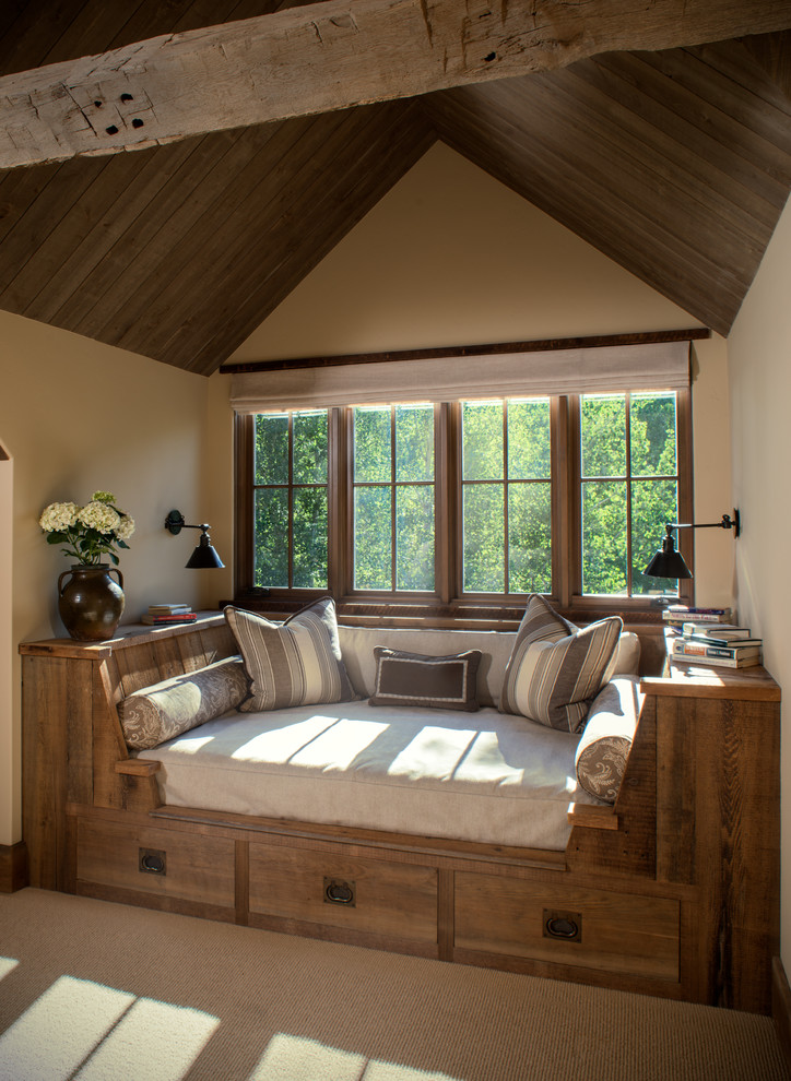 Example of a mid-sized mountain style carpeted family room design in Other with beige walls