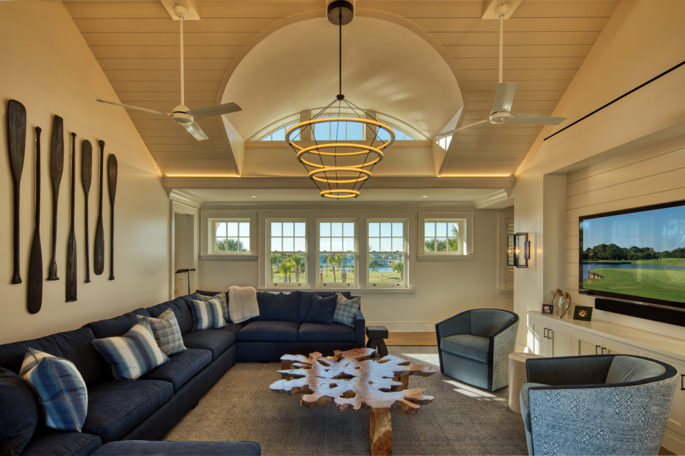 Inspiration for a large nautical open plan games room in Jacksonville with white walls, light hardwood flooring, a wall mounted tv, brown floors, a vaulted ceiling and wood walls.
